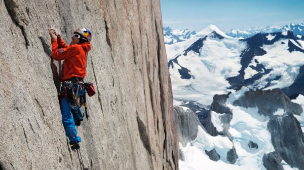 David Lama climbing in front of a beautiful panorama