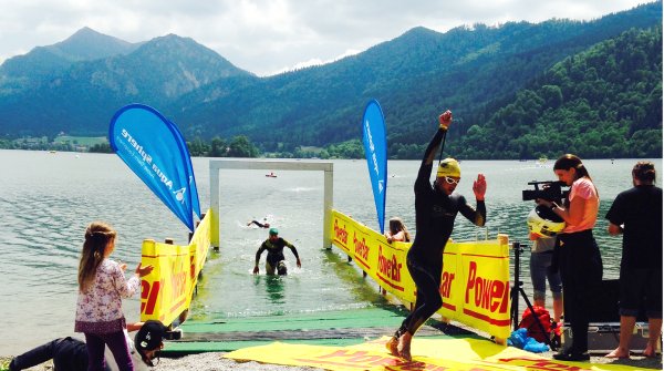 Participant of Schliersee triathlon in southern Bavaria while leaving swimming stage.