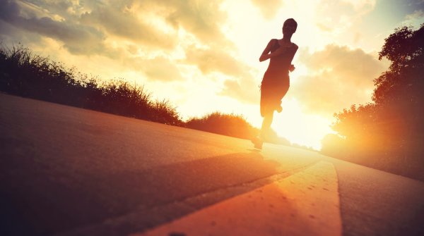 A woman running at sunset