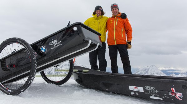 Stefan Glowacz und Robert Japser (orange) zeigen auf der Zugspitze, wie man die Carbon-Pulka als Rikscha verwenden kann.