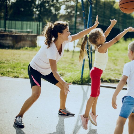 Mother plays basketball with her two children