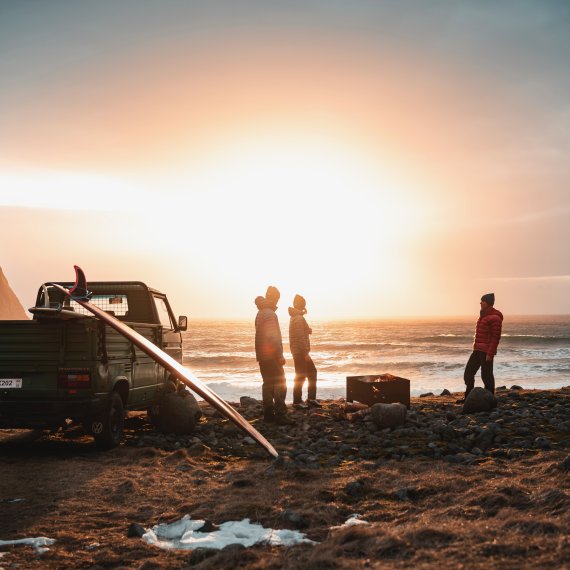 Outdoor Enthusiasten beobachten Sonnenuntergang am Meer