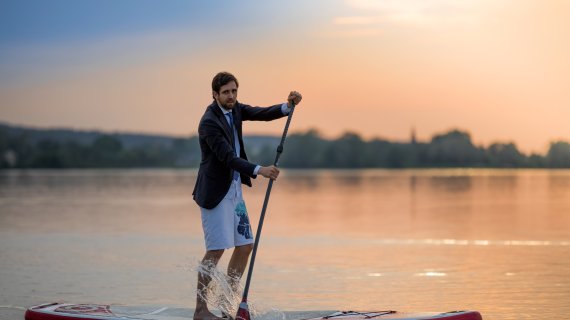 Prof. Dr. Manuel Sand auf einem Stand Up Paddle Board