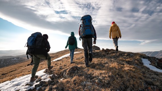 Four people hiking on a mountain