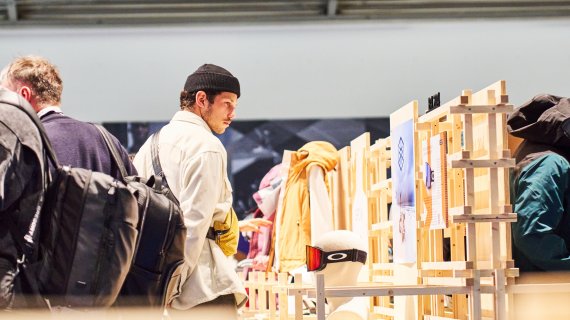 Person looks at an ISPO Award booth at ISPO 2024