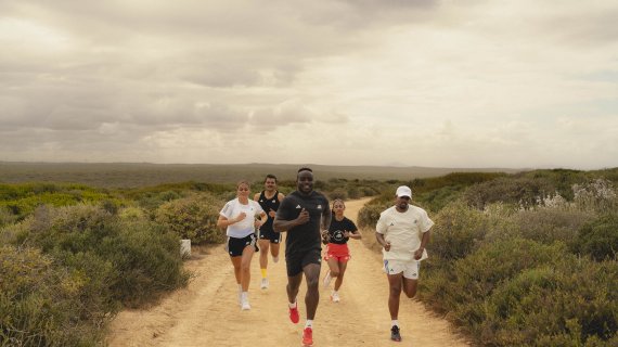 A group of runners jog through the countryside.