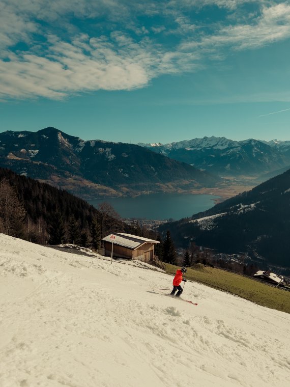 Skier skiing on artificially snowed slope in good weather